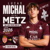 Lucas Michal wearing FC Metz jersey, smiling, with club logos of Metz and Monaco in background.