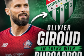 Olivier Giroud wearing Lille jersey, looking focused during a match, hinting at transfer talks with Bursaspor.