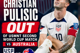 Christian Pulisic sitting on the field clutching his knee, injured during the USMNT match against Australia in FIFA World Cup