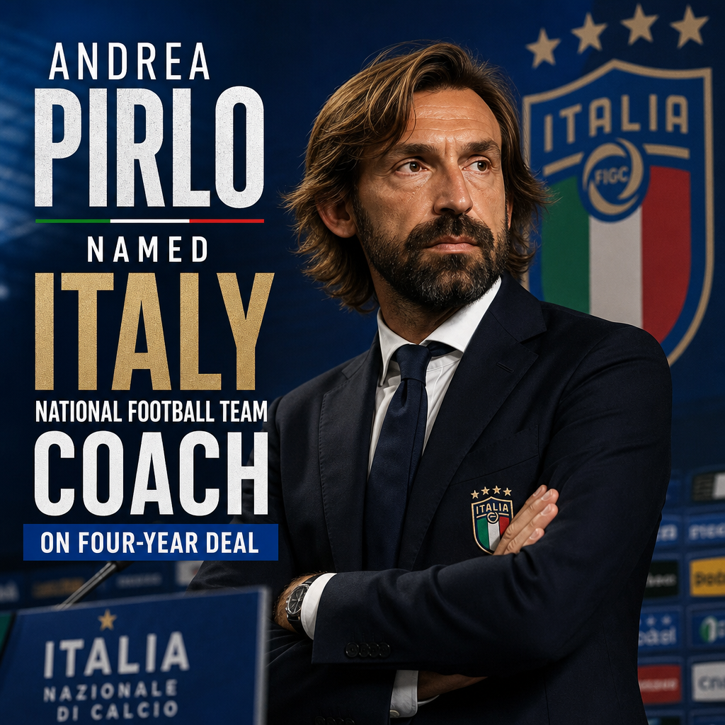 Andrea Pirlo smiling in a suit, posing for the camera at a press conference as Italy national football team coach.