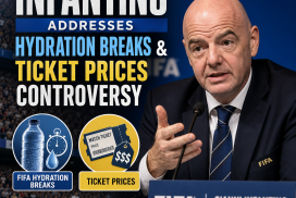 FIFA President Gianni Infantino speaking at a conference with microphones and FIFA backdrop.