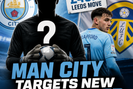 Manchester City goalkeeper in action, preparing to block a shot during a match.