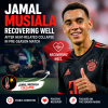 Jamal Musiala in Bayern Munich training kit, jogging on the field during a sunny pre-season match.