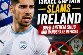 Israel captain Manor Solomon speaking passionately during a football match, wearing a white jersey.