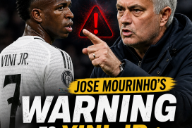 Jose Mourinho pointing and speaking firmly to Vini Jr. with a serious expression during a football match.