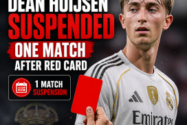 Real Madrid defender Dean Huijsen showing a red card during a match, suspended for one game.