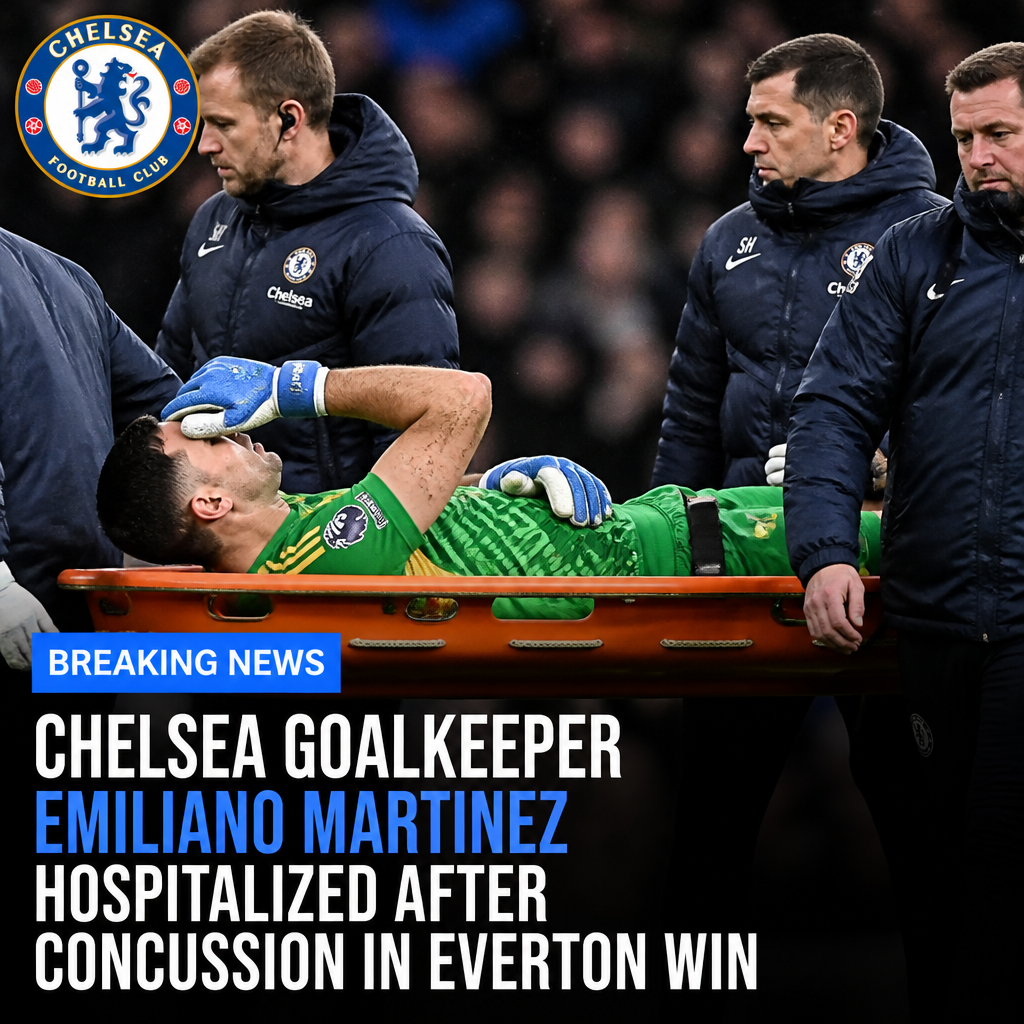 Chelsea goalkeeper Emiliano Martinez lies on the ground receiving medical attention after a concussion during a match.