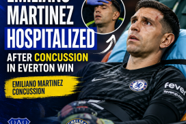 Chelsea goalkeeper Emiliano Martinez being helped off the field after a concussion during a match against Everton.