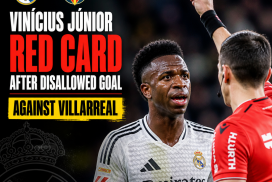 Vinícius Júnior holding a red card shown by the referee during a Real Madrid vs Villarreal match.