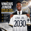 Vinicius Junior signing a six-year contract extension with Real Madrid, smiling and holding a pen.